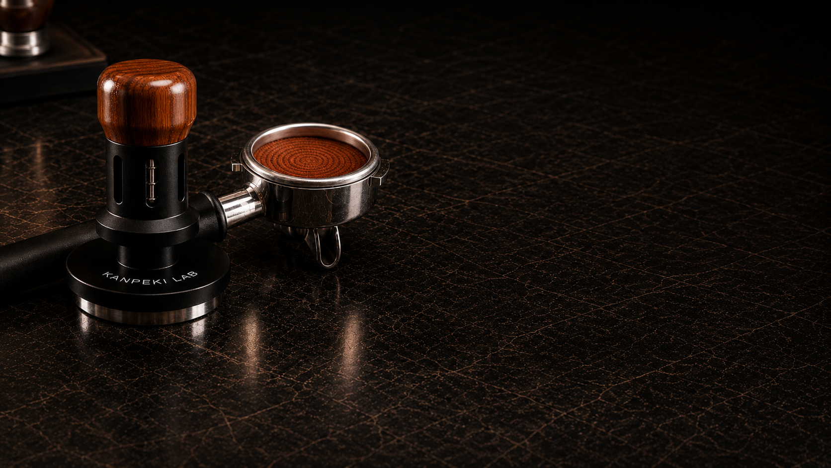 Kanpeki Lab V1 Calibrated Tamper with portafilter and a tamped puck on dark leather